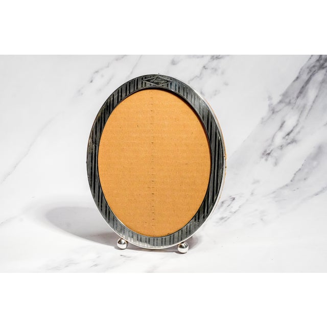 An elegant example of early 20th-century American silver craftsmanship, this antique sterling silver picture frame by...