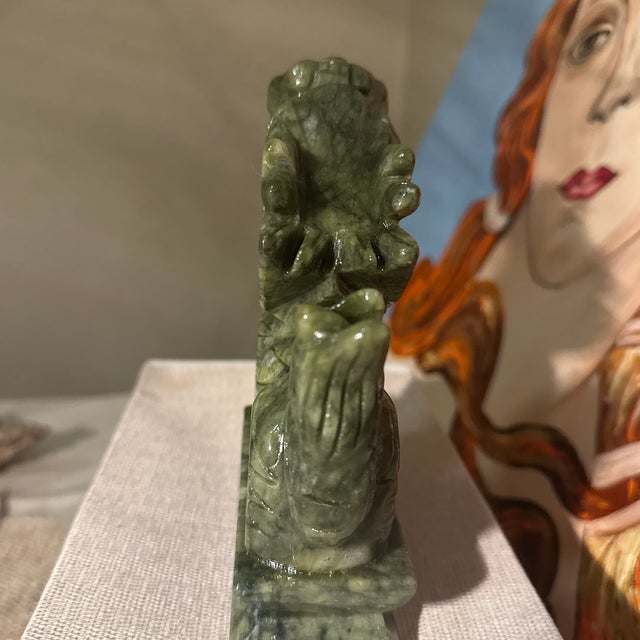 The stone displays beautiful natural color variation ranging from deep spinach green to lighter celadon tones, with subtle...