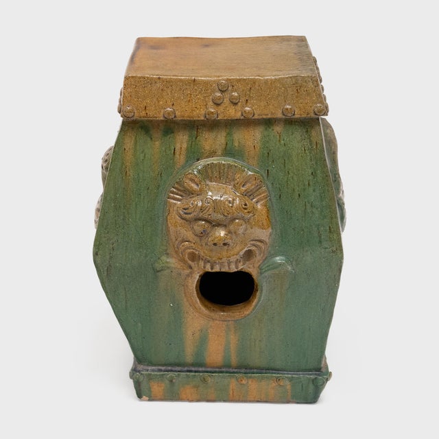 This low, ceramic garden drum is drip glazed in the manner of ancient Chinese sancai ware, cloaked in luminous shades of...