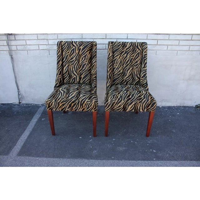 Very elegant pair of Mid-Century Modern side, end, fireside chairs with a padded back and a spring seat, newly upholstered...