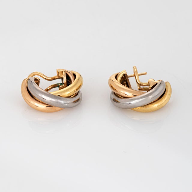 Stylish Cartier Trinity earrings crafted in 18k yellow, rose & white gold (circa 1990s). The classic Trinity earrings are...