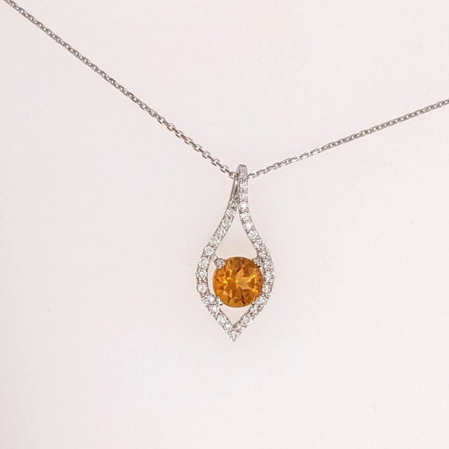 This beautiful pendant features a 0.92 carat round citrine with natural earth mined diamonds, all set in solid 14k gold. A...