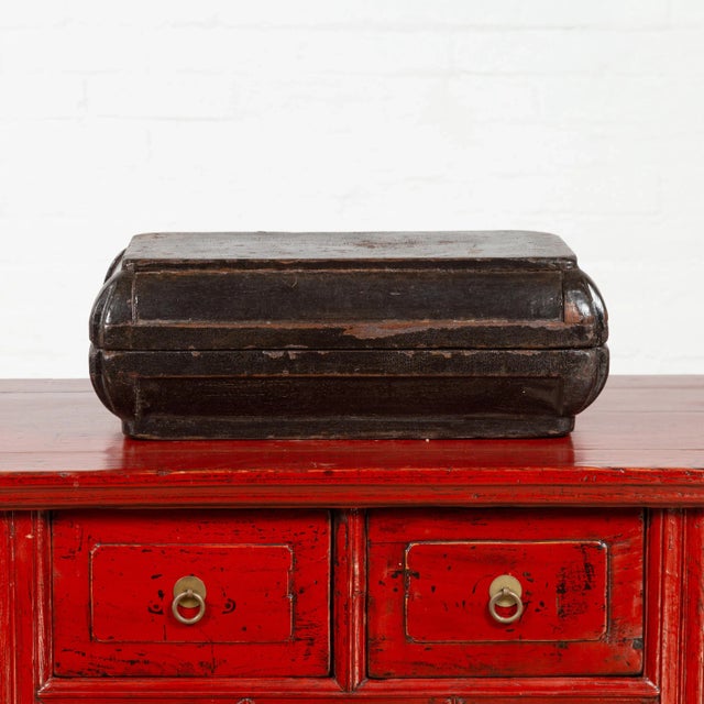 A small antique Chinese dowry basket from the early 20th century, with brown patina and weathered appearance. Charming our...