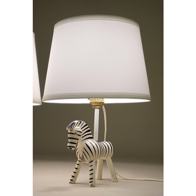 A rare and charming matched pair of Kay Bojesen hand painted brilliant Danish Modern Zebra table lamp designs produced in...