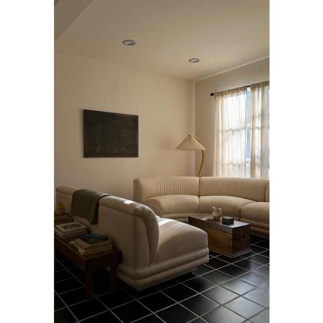 A sculptural vintage three-piece modular sectional sofa featuring a sweeping curved silhouette, generous proportions, and...