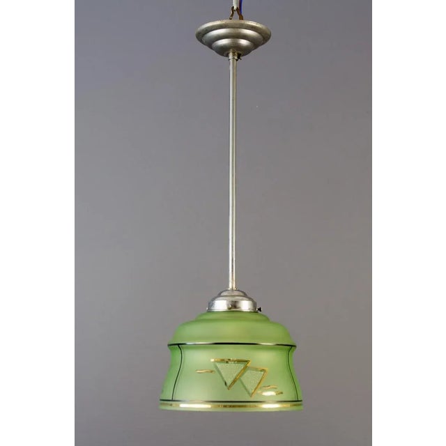 Art Deco Chrome and Green Glass Pendant, 1930s. French Art Deco chromed brass and a green glass pendant from circa the...