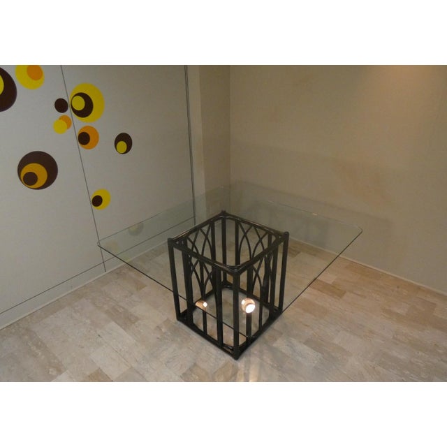 A black lacquered oak and beech table with leather binding and a tempered glass top\. a classic design by Lyda Levi for...