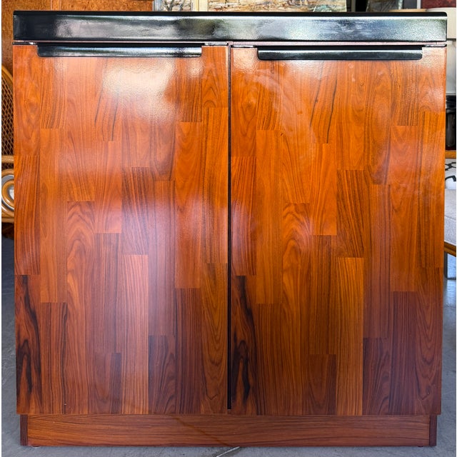 Mid-century modern rosewood highboy dresser/cabinet manufactured by Maurice Villency in Belgium during the 1970s. It...