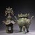 This striking antique bronze incense burner, or censer, features a unique, two-part design modeled as a pagoda or tower....