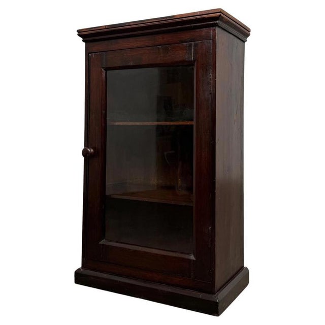 A charming early 20th-century English Edwardian cabinet, beautifully constructed in pine and distinguished by its glazed...