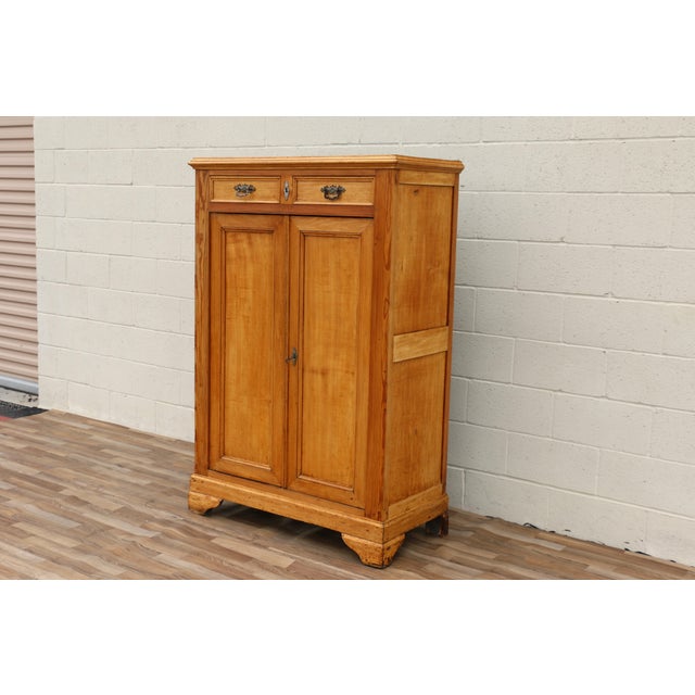 This beautiful antique Vertiko cabinet dates to the 1890s and is crafted from solid pine wood with a warm natural finish...