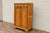 This beautiful antique Vertiko cabinet dates to the 1890s and is crafted from solid pine wood with a warm natural finish...