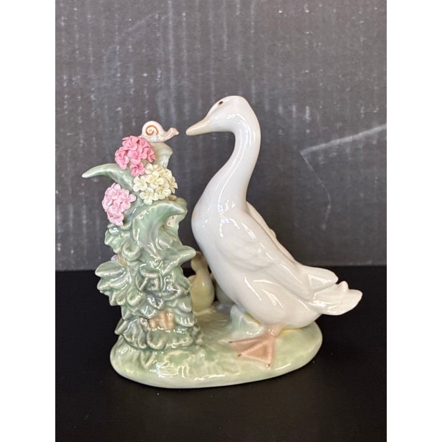 This is a glossy porcelain "How Do You Do?" duck figurine from Lladro, featuring a mother duck, three ducklings, and a...
