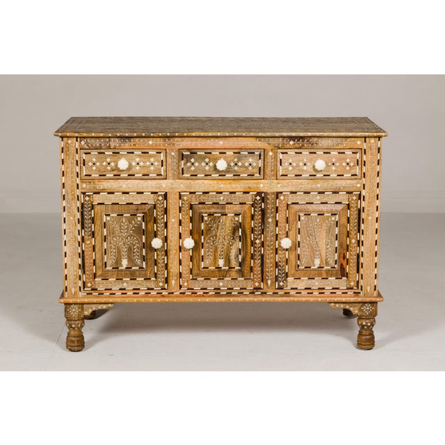 Anglo-Indian style richly inlaid mango wood buffet with three drawers over three doors and dark patina. This Anglo-Indian...