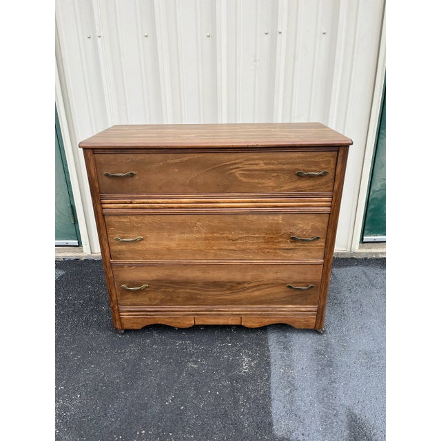 A beautiful walnut chest of drawers from the mid-20th century. Features three full width drawers with beautiful twisted...