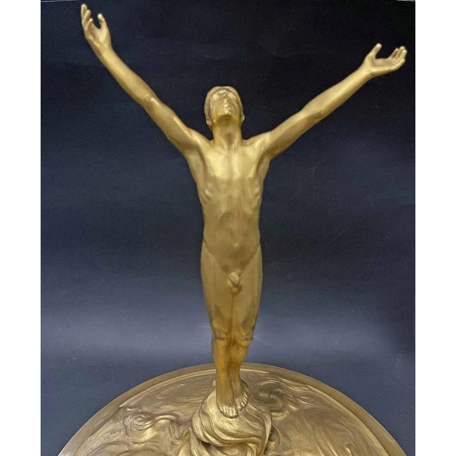"Triumphant Man," Gilded Bronze Trophy Cup, France. Large and spectacular, this gilded bronze trophy cup in the Art...