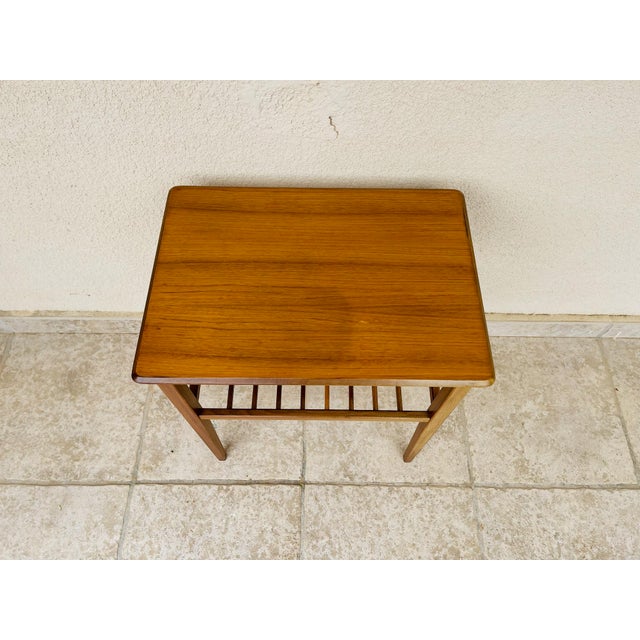 Elegant vintage teak console or side table, characterized by a clean design typical of 1960s Scandinavian style. Its...