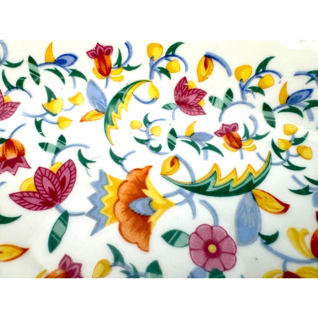 This 1940's German oval bowl is a delightful expression of hand-painted craftsmanship, bursting with floral motifs in a...