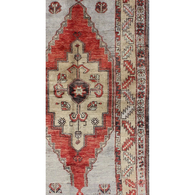 Vintage Turkish small Oushak Carpet with Geometric Medallion in soft orange Red and multi colors, Small Oushak rug, Keivan...