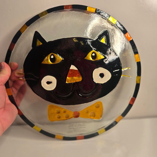 This is a Halloween Silvestri Lori Siebert Bowtie Cat Plate, likely a fused glass decorative dish. The plate features a...
