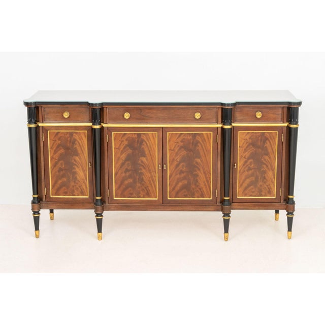 John Widdicomb Flame Mahogany Sideboard, the glass top above central drawer and cabinet flanked by short two short drawers...