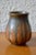 This sphere-shaped vase was created at the Elchinger Pottery. In a very raw appearance, the ochres of the earth are...