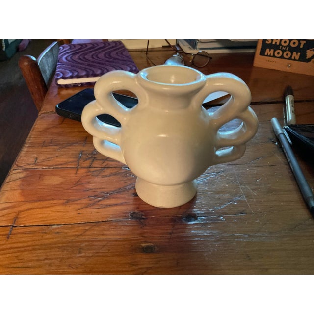 This is the cutest mini vase in a mid century contemporary style. With three loops on each side for handles.. looks great...