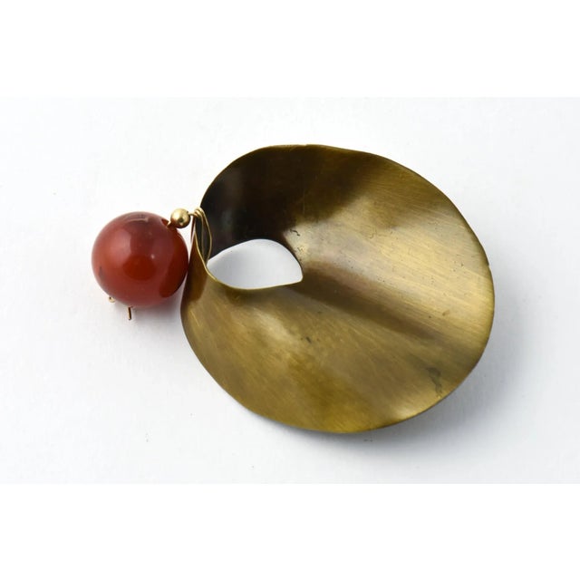 Dramatic Modernistic Mexican Sterling Silver Brooch with a brass finish dangling a Carnellian ball accent.