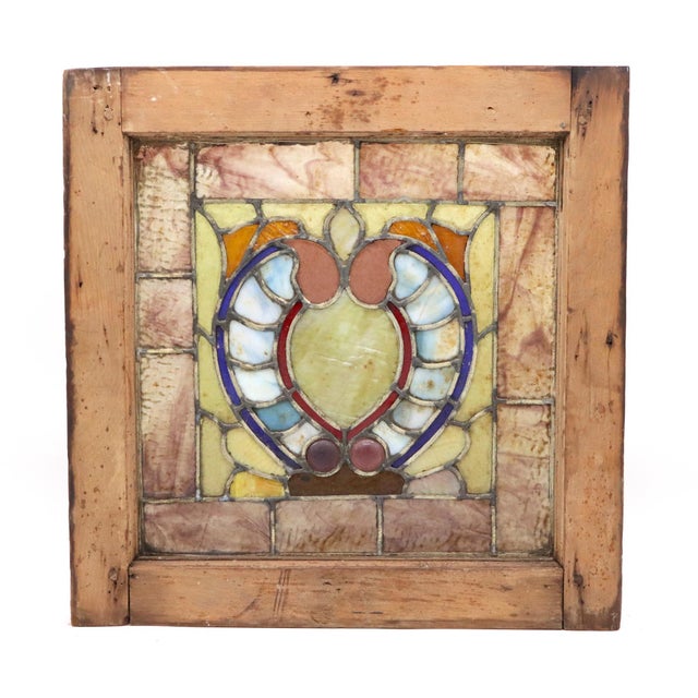 Pair of Arts & Crafts stained glass windows with unfinished wood frames. The panels feature a range of marbled glass in...