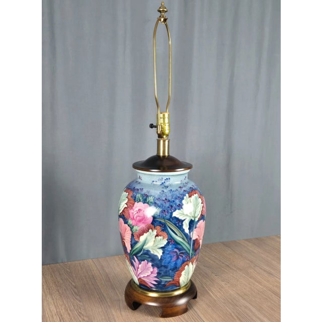 Beautiful table lamp with hand painted floral porcelain, brass trim, wood top and base. Retains Frederick Cooper sticker...