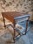 This writing desk was made in France in the 1930s. It is constructed from solid walnut wood and stands on turned legs...