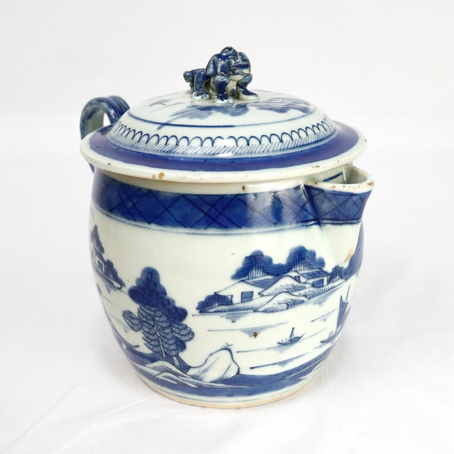 A fine antique Chinese Export porcelain lidded cider jug. In the Canton pattern. Decorated in underglaze blue with a...