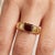 Elevate your look with a seamless balance of clean, industrial geometry and rich, deep crimson tones. This striking...