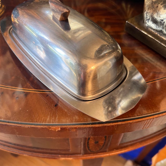 Super cool authentic 1970s metal and wood butter holder. Geometric wooden handle gives this butter dish serous style!...