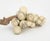 A substantial vintage marble grape-cluster sculpture resting on a beautifully textured natural grapevine branch. The...