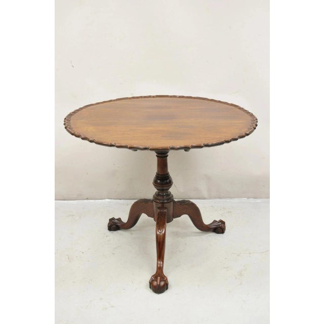 Antique Georgian Chippendale Style Pie Crust Mahogany Ball and Claw Tilt Top Table. Item features a bird cage pedestal...