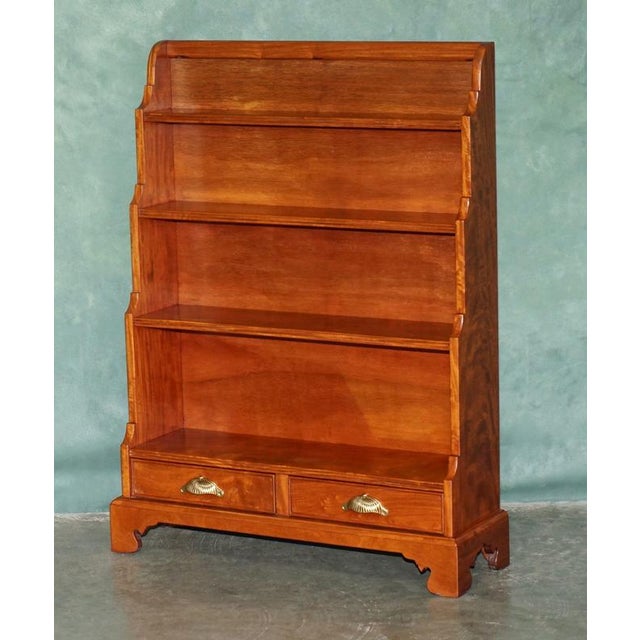Beautiful matching pair of mahogany dwarf open library bookcases, designed in the elegant Regency tradition with graduated...