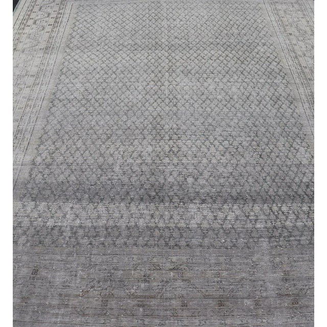Measures: 8'0 x 11'2 Distressed Persian Antique Tabriz Carpet with Muted Floral Design in Light Gray Keivan Woven Arts/...