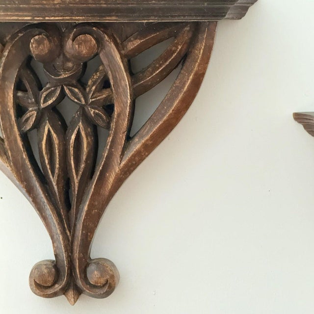 A pair of hand carved ornate decorative wall shelves. Measurements w: 31cm h: 25cm d: 14cm condition used vintage...