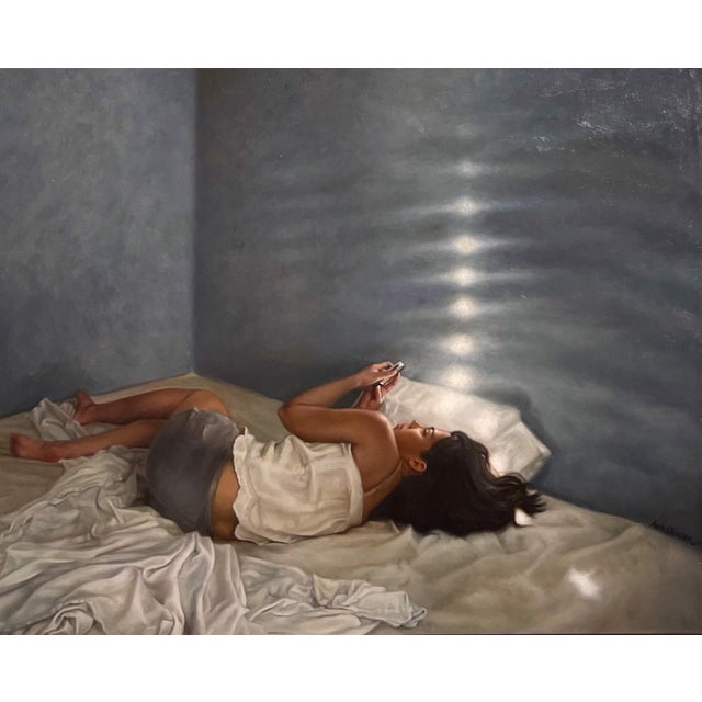 Desvelada by Aixa Oliveras | Oil on canvas Woman lying on a bed, using a phone in a softly lit room. For Sale