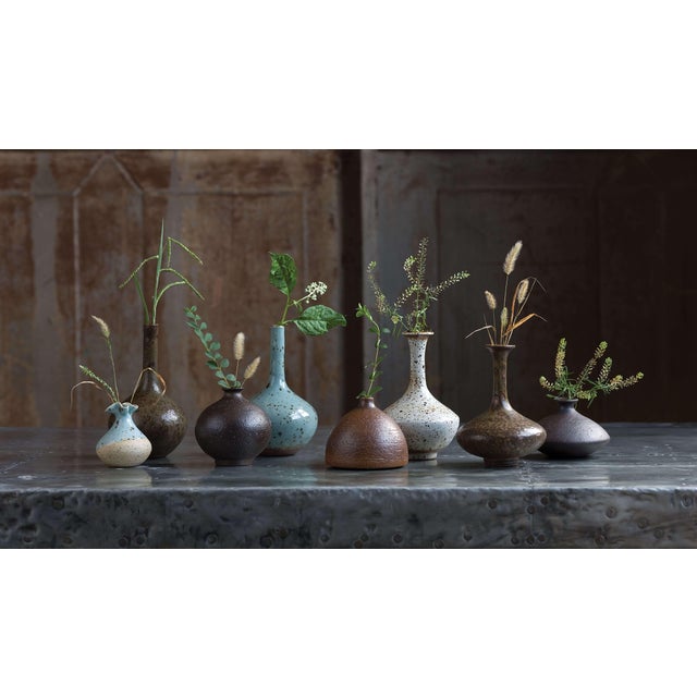 This set of 8 delicate porcelain bud vases makes for an eclectic, handmade look. Varying shapes, sizes and colors — from...
