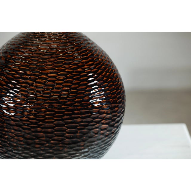 With its sculptural presence and richly tactile surface, this large artisan ceramic vase captures the interplay of form,...