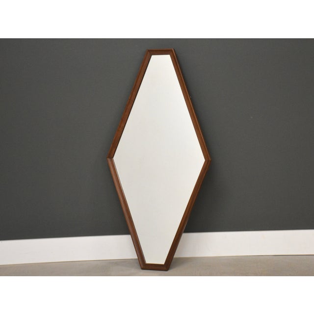 A mid century modern walnut diamond shaped mirror. 24.25” wide. 47.75” tall.