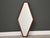 A mid century modern walnut diamond shaped mirror. 24.25” wide. 47.75” tall.