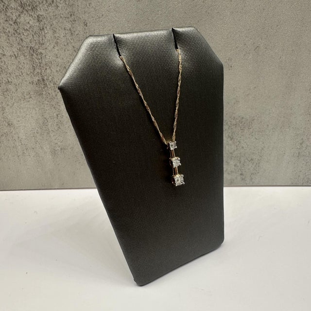 This meaningful diamond past, present, future necklace in 10kt yellow gold features 0.03 carats total weight of natural I,...