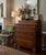 A distinctive vintage tall chest of drawers by Lane Furniture of Altavista, Virginia, combining generous storage with...