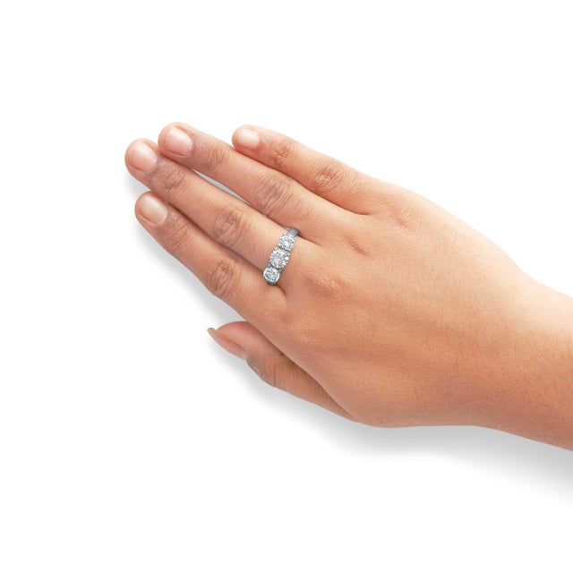 Crafted in radiant 14K white gold with a sleek rhodium-plated finish, this exquisite 3-stone band ring captures the...