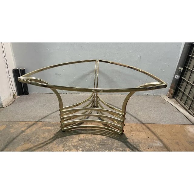 Dining table with a singular shape, brass structure and comic glass', in excellent condition.