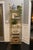 Offered is a metal etagere with faux bamboo details and five removable glass shelves. This piece was recently painted...