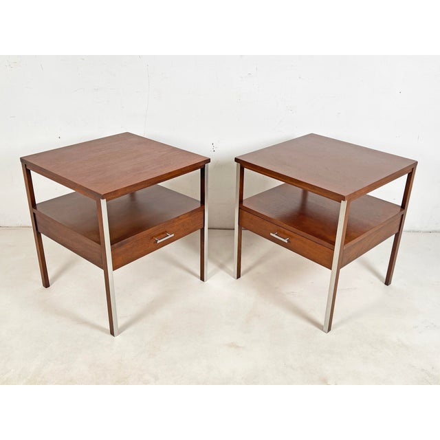 A pair of 1960s single drawer side tables in walnut and aluminum by Paul McCobb for Calvin Furniture’s Linear Group...